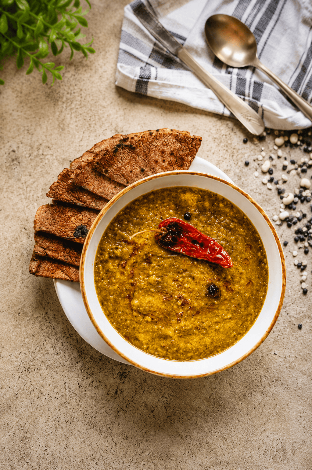A bowl of Chainsoo, a smooth dark dal made from roasted and ground black gram, topped with ghee